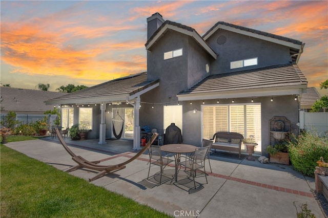 43650 Buckeye Rd, Temecula, CA 92592 - back of property featuring a patio area, a tile roof, a chimney, and stucco siding