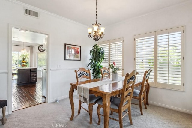 43650 Buckeye Rd, Temecula, CA 92592 - carpeted dining room featuring a chandelier, baseboards, healthy amount of natural light, and crown molding