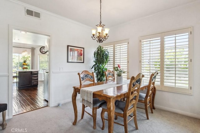 43650 Buckeye Rd, Temecula, CA 92592 - dining room featuring a chandelier, carpet, crown molding, and plenty of natural light