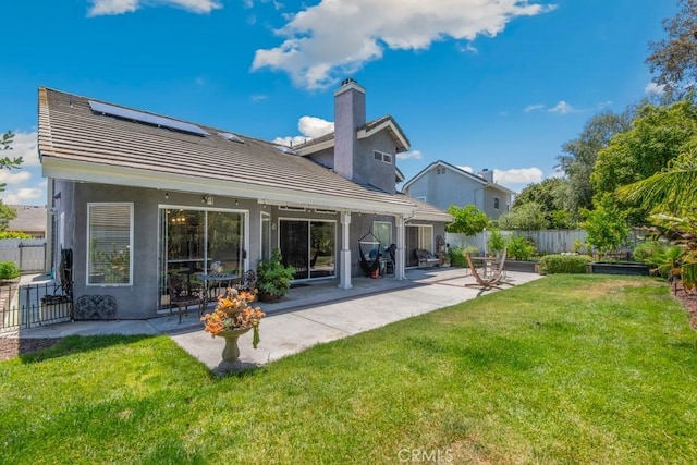 43650 Buckeye Rd, Temecula, CA 92592 - rear view of property with roof mounted solar panels, a chimney, a patio, a tile roof, and stucco siding