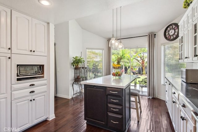43650 Buckeye Rd, Temecula, CA 92592 - kitchen featuring white cabinets, dark wood-type flooring, glass insert cabinets, lofted ceiling, and recessed lighting