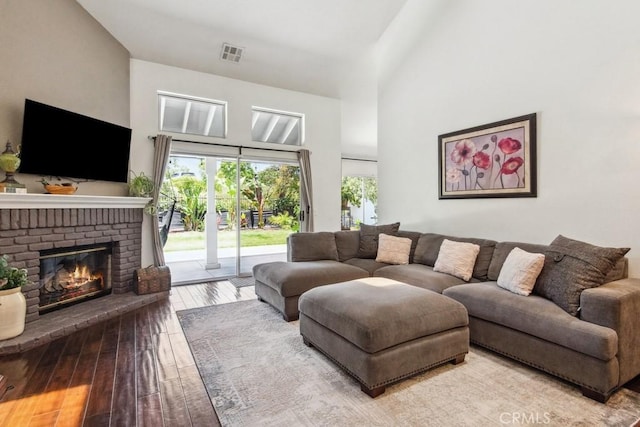 43650 Buckeye Rd, Temecula, CA 92592 - living area with a fireplace, hardwood / wood-style floors, and a towering ceiling