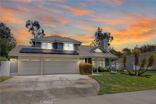 43650 Buckeye Rd, Temecula, CA 92592 - traditional home featuring driveway, roof mounted solar panels, a chimney, a tiled roof, and an attached garage