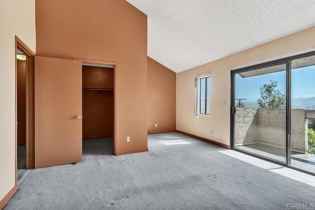368 Travelodge Dr, El Cajon, CA 92020 - unfurnished bedroom featuring access to outside, multiple windows, carpet floors, baseboards, and a textured ceiling