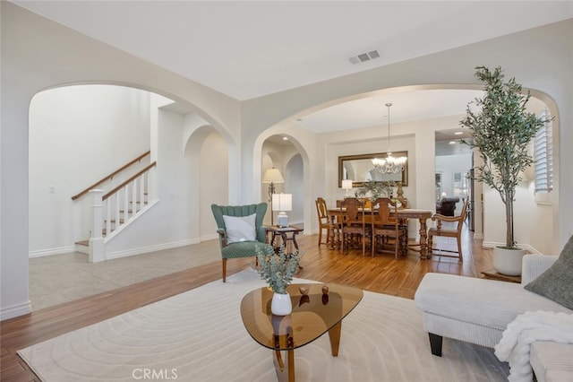 24923 Hearth Ct, Valencia, CA 91354 - living area with wood finished floors, stairs, arched walkways, and baseboards