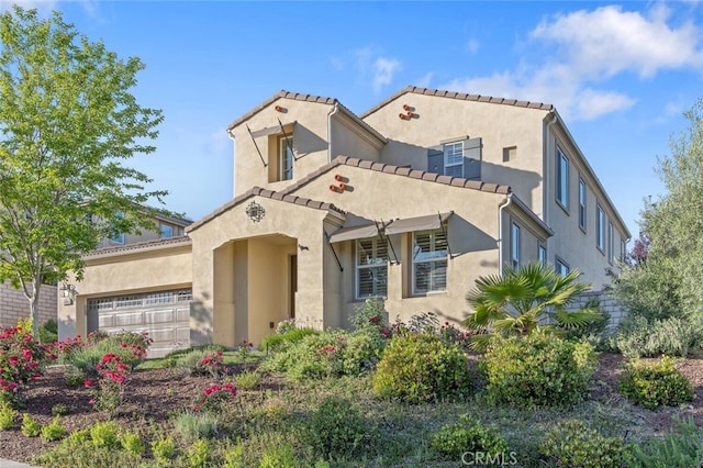 24923 Hearth Ct, Valencia, CA 91354 - mediterranean / spanish-style house with stucco siding, a garage, and a tiled roof