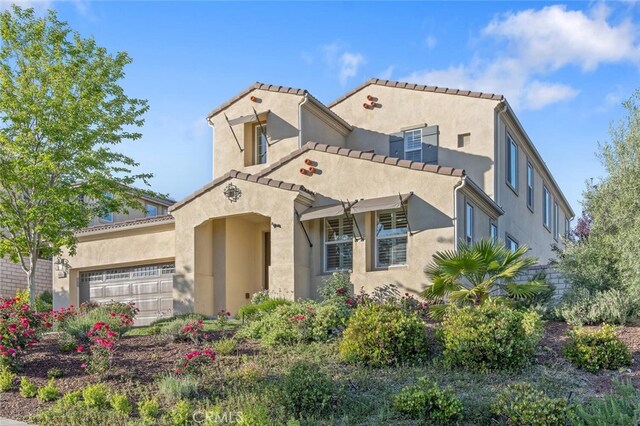 24923 Hearth Ct, Valencia, CA 91354 - mediterranean / spanish-style home featuring stucco siding, an attached garage, and a tiled roof