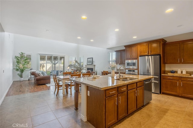 24923 Hearth Ct, Valencia, CA 91354 - kitchen with appliances with stainless steel finishes, a sink, open floor plan, recessed lighting, and light stone countertops
