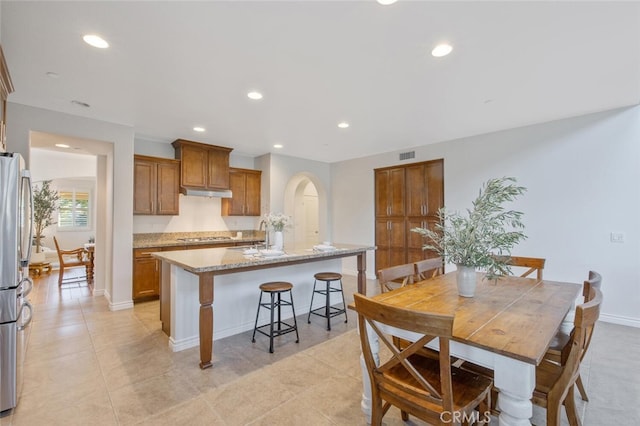 24923 Hearth Ct, Valencia, CA 91354 - dining space featuring recessed lighting, baseboards, arched walkways, and light tile patterned floors