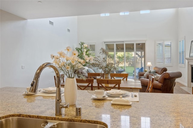 24923 Hearth Ct, Valencia, CA 91354 - detailed view of a sink, light stone countertops, and a fireplace