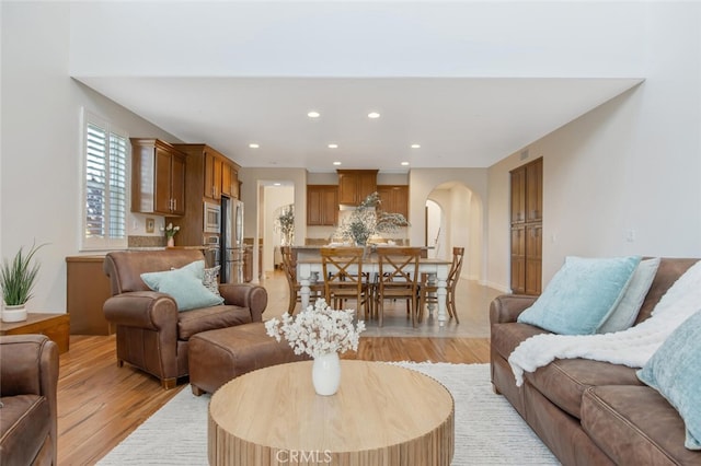 24923 Hearth Ct, Valencia, CA 91354 - living area featuring light wood finished floors, recessed lighting, and arched walkways