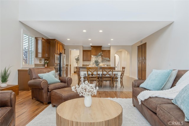 24923 Hearth Ct, Valencia, CA 91354 - living area featuring light wood-style floors, recessed lighting, and arched walkways