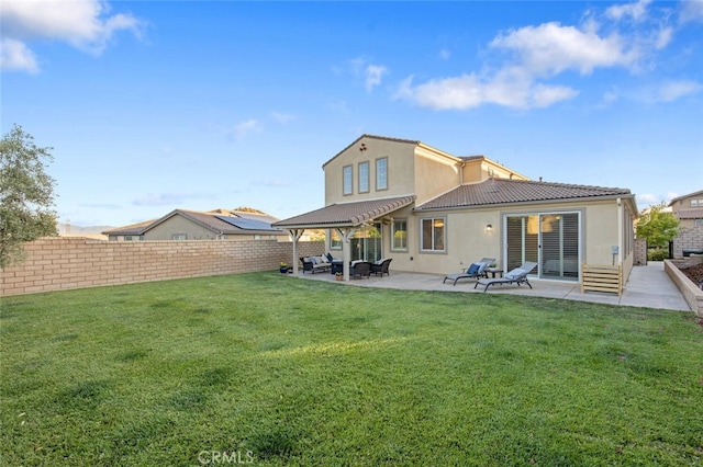 24923 Hearth Ct, Valencia, CA 91354 - back of property featuring stucco siding, a fenced backyard, a patio, an outdoor hangout area, and a tile roof