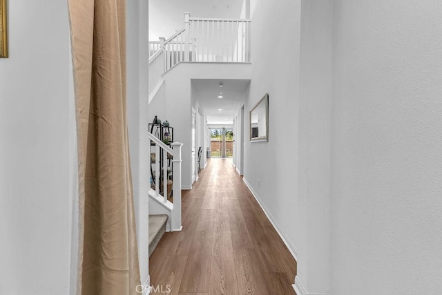 30536 Astoria Ln, Murrieta, CA 92563 - corridor featuring stairs, wood finished floors, and baseboards