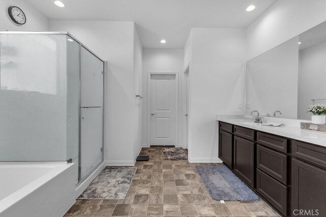 30536 Astoria Ln, Murrieta, CA 92563 - full bath featuring vanity, a shower stall, baseboards, a bath, and recessed lighting