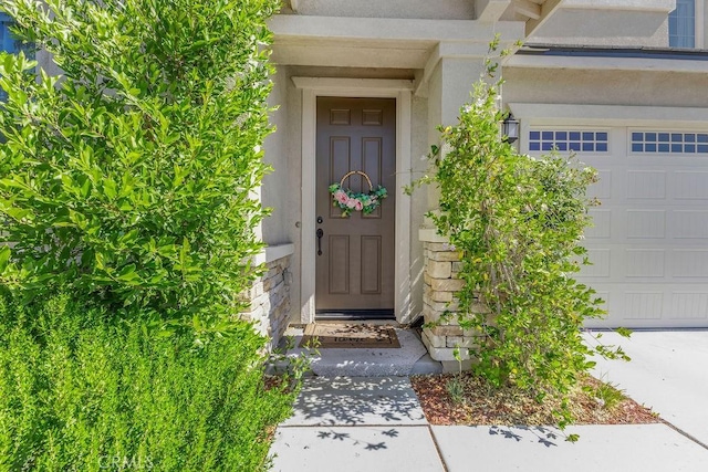 30536 Astoria Ln, Murrieta, CA 92563 - property entrance with stucco siding, stone siding, and a garage
