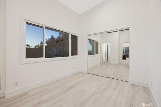 23835 Bella Vista Dr, Newhall, CA 91321 - unfurnished bedroom with wood finished floors, a closet, baseboards, and high vaulted ceiling