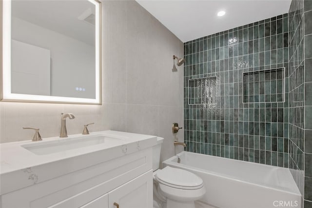 23835 Bella Vista Dr, Newhall, CA 91321 - bathroom featuring tile walls, vanity, and bathtub / shower combination