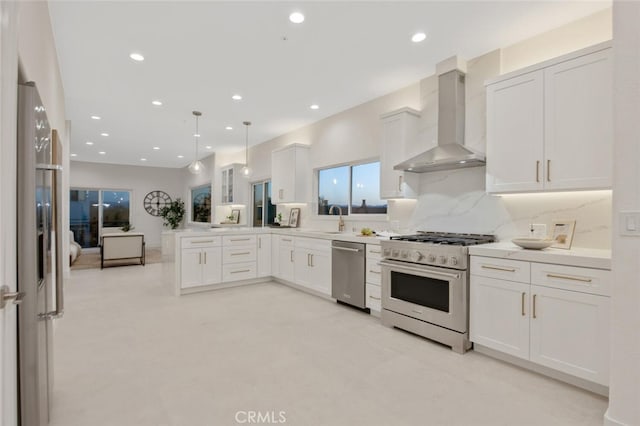 23835 Bella Vista Dr, Newhall, CA 91321 - kitchen featuring stainless steel appliances, wall chimney range hood, a peninsula, recessed lighting, and white cabinetry