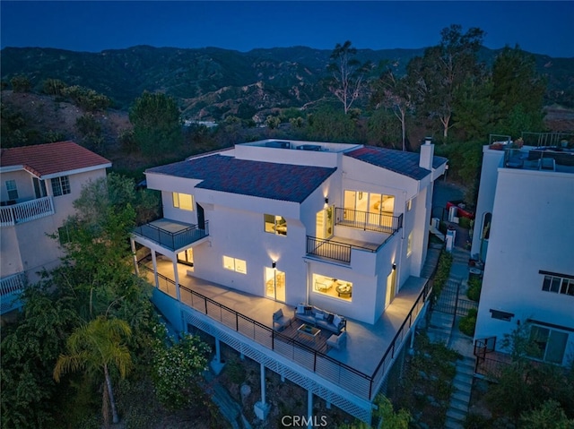 23835 Bella Vista Dr, Newhall, CA 91321 - rear view of property with a balcony, stucco siding, a chimney, a mountain view, and an outdoor living space