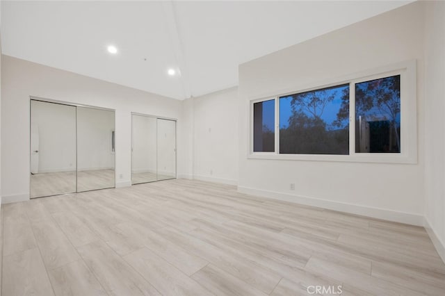 23835 Bella Vista Dr, Newhall, CA 91321 - unfurnished bedroom featuring two closets, light wood finished floors, recessed lighting, and lofted ceiling