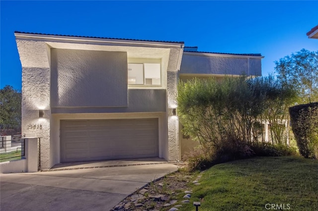 23835 Bella Vista Dr, Newhall, CA 91321 - view of front facade featuring stucco siding, driveway, and an attached garage