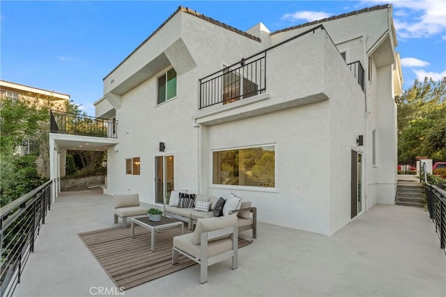 23835 Bella Vista Dr, Newhall, CA 91321 - rear view of house with a balcony, stucco siding, an outdoor living space, and a patio