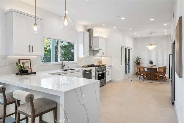 23835 Bella Vista Dr, Newhall, CA 91321 - kitchen with wall chimney range hood, stainless steel appliances, light stone counters, white cabinetry, and recessed lighting
