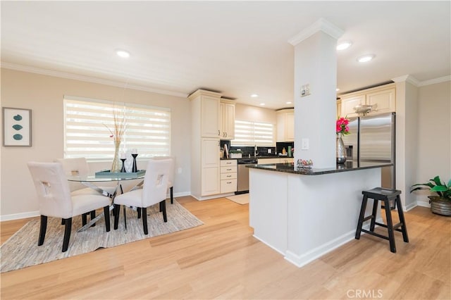 3438 Bahia Blanca W Unit B, Laguna Woods, CA 92637 - kitchen featuring stainless steel appliances, light wood-style floors, cream cabinetry, a kitchen island, and crown molding