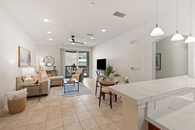 1225 Island Ave Unit 503, San Diego, CA 92101 - living area featuring arched walkways, light tile patterned floors, recessed lighting, ceiling fan, and baseboards
