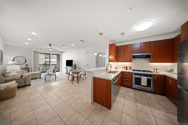 1225 Island Ave Unit 503, San Diego, CA 92101 - kitchen with stainless steel appliances, a peninsula, open floor plan, a sink, and recessed lighting