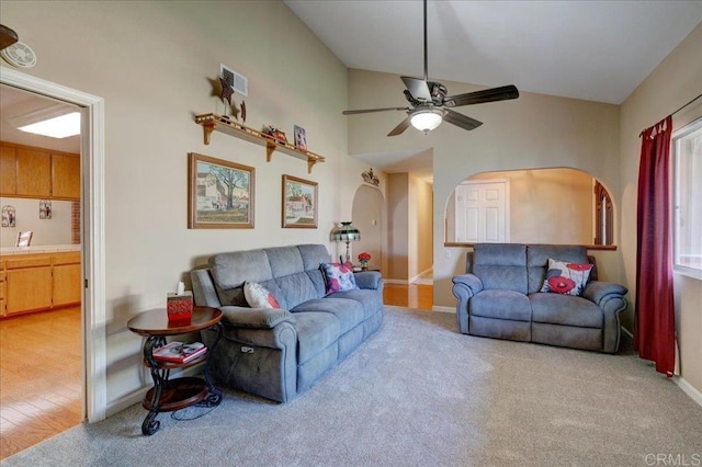 221 E Old Julian Hwy, Ramona, CA 92065 - living room featuring arched walkways, vaulted ceiling, a ceiling fan, baseboards, and light colored carpet