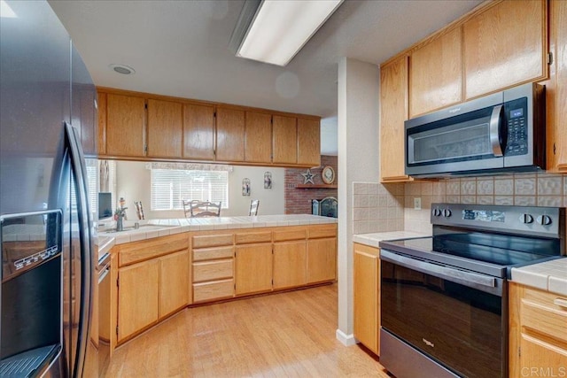 221 E Old Julian Hwy, Ramona, CA 92065 - kitchen with stainless steel appliances, light wood-type flooring, backsplash, and tile counters