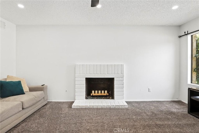 12518 Bernadette St, Pacoima, CA 91331 - unfurnished living room with carpet flooring, recessed lighting, a textured ceiling, a brick fireplace, and baseboards