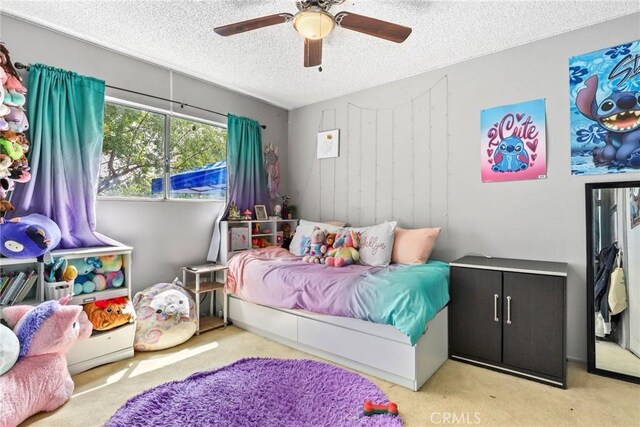 12518 Bernadette St, Pacoima, CA 91331 - bedroom with a textured ceiling, carpet, and a ceiling fan