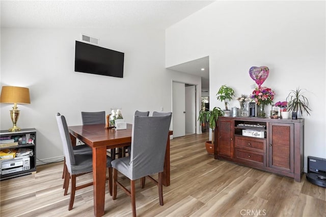 12518 Bernadette St, Pacoima, CA 91331 - dining space featuring light wood finished floors and vaulted ceiling