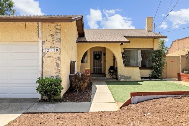 12518 Bernadette St, Pacoima, CA 91331 - view of front of property featuring stucco siding, a chimney, an attached garage, and roof with shingles