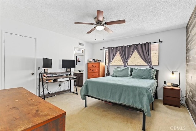 12518 Bernadette St, Pacoima, CA 91331 - bedroom with light colored carpet, a textured ceiling, and ceiling fan