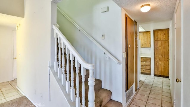 8471 Evergreen, Garden Grove, CA 92841 - stairway featuring a textured ceiling and tile patterned floors
