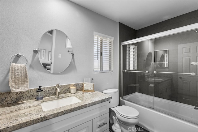 22565 Pecan Pl, Saugus, CA 91390 - bathroom featuring toilet, vanity, shower / bath combination with glass door, and a textured wall