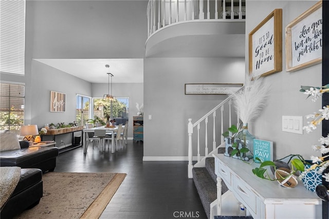 22565 Pecan Pl, Saugus, CA 91390 - foyer entrance with stairs, a high ceiling, dark wood-style floors, and baseboards