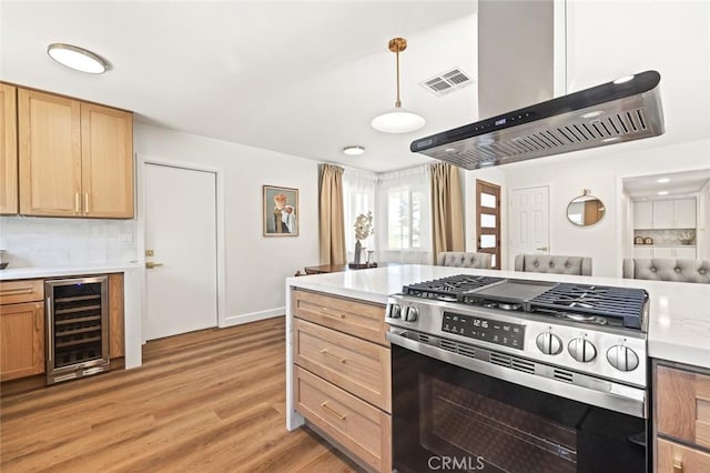 20853 Moonlake St, Diamond Bar, CA 91789 - kitchen featuring gas stove, beverage cooler, wall chimney range hood, light countertops, and decorative backsplash
