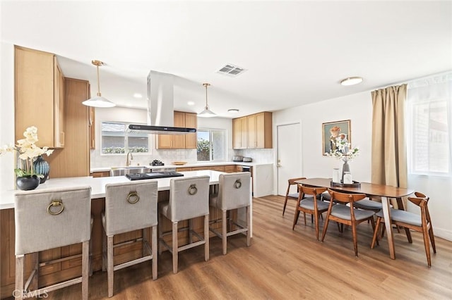 20853 Moonlake St, Diamond Bar, CA 91789 - kitchen with island range hood, light wood finished floors, a peninsula, a sink, and light countertops