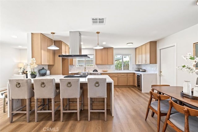 20853 Moonlake St, Diamond Bar, CA 91789 - kitchen with wall chimney range hood, a peninsula, beverage cooler, decorative backsplash, and light wood-style flooring