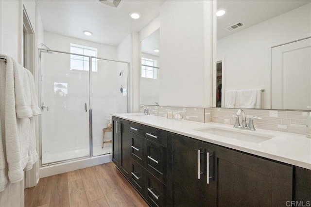 4366 Pacifica Way Unit 5, Oceanside, CA 92056 - bathroom featuring double vanity, a stall shower, tasteful backsplash, wood finished floors, and a spacious closet