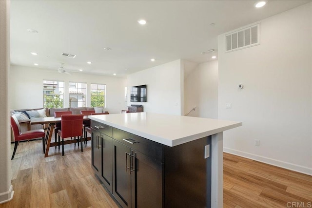 4366 Pacifica Way Unit 5, Oceanside, CA 92056 - kitchen with light wood finished floors, open floor plan, a center island, light countertops, and recessed lighting