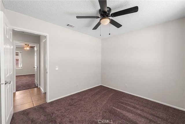 38115 41st St E, Palmdale, CA 93552 - carpeted spare room featuring ceiling fan, a textured ceiling, baseboards, and tile patterned flooring