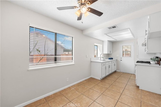 38115 41st St E, Palmdale, CA 93552 - kitchen with a sink, light tile patterned floors, light countertops, ceiling fan, and baseboards