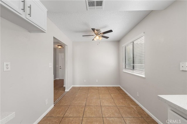 38115 41st St E, Palmdale, CA 93552 - spare room with a ceiling fan, light tile patterned floors, a textured ceiling, and baseboards