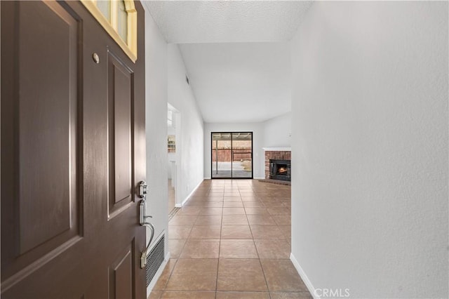 38115 41st St E, Palmdale, CA 93552 - hallway featuring light tile patterned floors, baseboards, and a textured ceiling